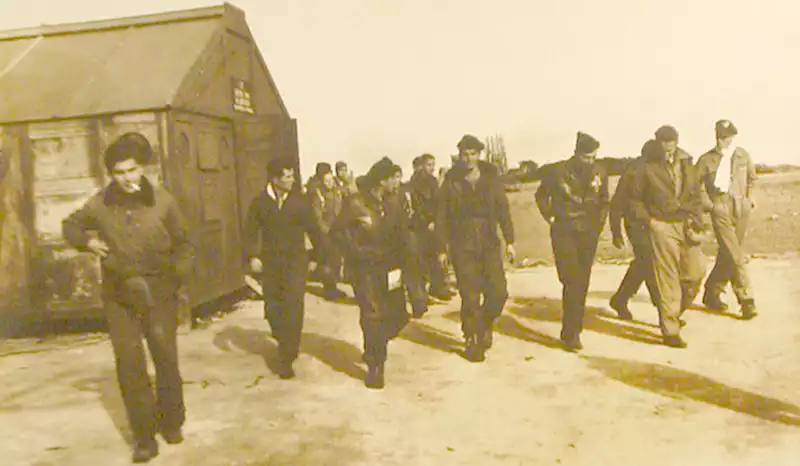 Men coming out of an indoor mission briefing. Photo by Quentin Kaiser.