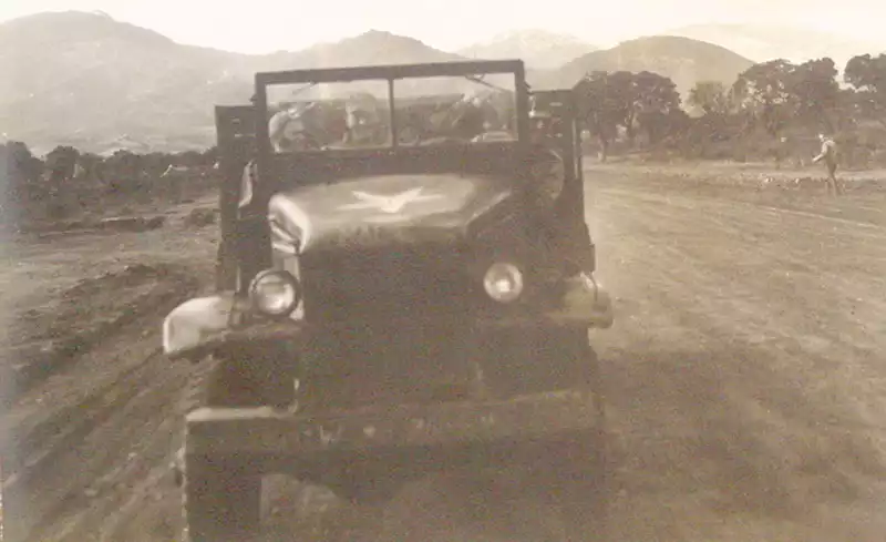 Men in a jeep on their way to their B-25s. Photo by Quentin Kaiser.