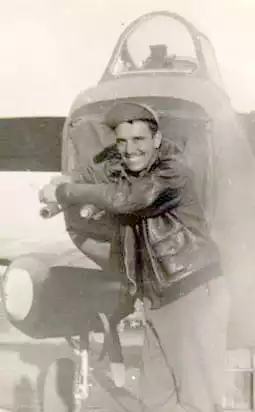 Quentin Kaiser resting over two 50-caliber machine guns in the tail of a B-25J Mitchell.