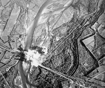 Picture of bombs exploding around a targeted bridge.