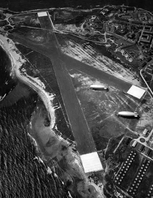 Aerial oblique view of the blimp area Elizabeth Field on Fisher's Island, NY with two blimps tethered.