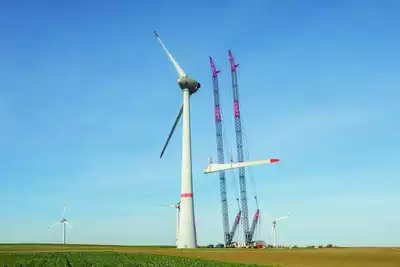 Cranes installing a blade