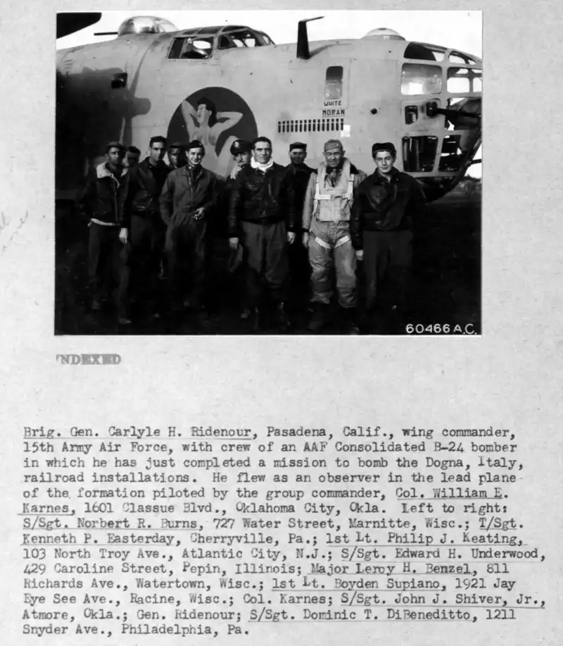 Brig General CH Ridenour, Wing Commander 15th Army Air Force with crew of a B-24 bomber in which he had just flown a mission, as an observer, to bomb Dogna, Italy railroad installation.