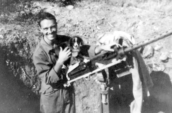 QCK with dog 'CANADAK' in defensive 50 caliber gun trench behind his tent at Alesani.