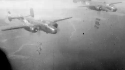 Picture of B-25J 9W 'Morning Mission' and another B-25, each releasing four 1000-pound bombs on a mission.