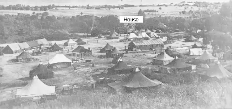 The 489th tent camp showing Q. Kaiser's tent and the old RR station house.