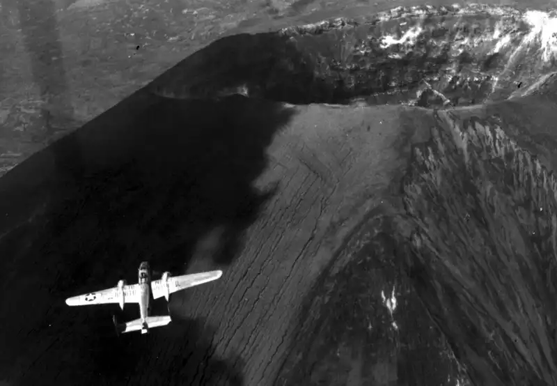 B-25J named Finito Benito Next Hirohito flying near the volcano in May 1945