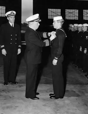 CAPT Fisher presenting Legion Of Merit to BM2c William A Garratt October 16, 1943