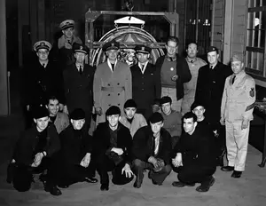 CAPT Frederick C Sachse and men around blimp engine February 14, 1943