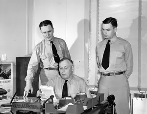 CDR Herbert S Horn CAPT James L Fisher LCDR Robert J Antrim in Fishers office May 25, 1944