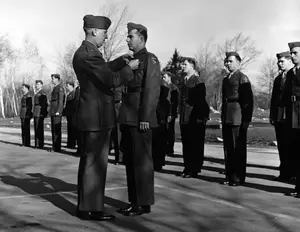 Maj Rockwell presenting Purple Heart to PFC John Wright March 26, 1945